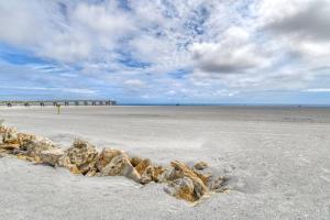 a beach with rocks in the sand and a pier at Pier Point 17 in St. Augustine