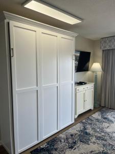 a large white closet in a room with a table at Summer Sands - 401 by Sea Scape Properties in Wrightsville Beach