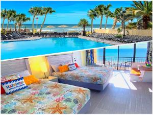 a hotel room with two beds and a swimming pool at New ! Ocean Reef Resort-Unique Renovated Oceanfront Condo -Free parking - Amazing pools & Views in Myrtle Beach