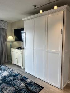 a large white cabinet in a room with a rug at Summer Sands - 402 by Sea Scape Properties in Wrightsville Beach