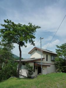 a house on a hill with a tree at Tentengo Shibu River - Vacation STAY 79348v in Ono