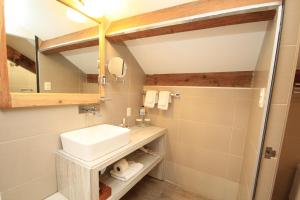 a bathroom with a sink and a mirror at Hotel Ciudad Real Centro Historico in San Cristóbal de Las Casas +53 photos