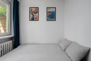 a bed in a room next to a window at Patro Apartament 2 Wrocław Centrum in Wrocław