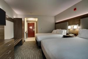 a hotel room with two beds and a television at Holiday Inn Express Durham-UNH by IHG in Durham