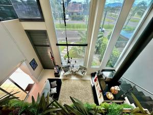 an image of a living room with large windows at Verão de Luxo no Condomínio Condado de Capão in Capão da Canoa