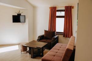a living room with a couch and a chair at Sevan - Artanish Beach Resort in Artanish