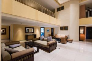 a large living room with couches and a table at W Studio Resort Suites in Petaling Jaya