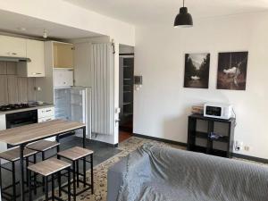 a living room with a table and a kitchen at Appartement 3 chambres proche gare Longwy in Longwy
