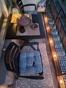 a table with a plate of donuts on a balcony at Bohemian Retro Room Varna in Varna City