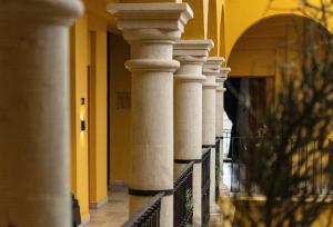 a row of white columns in a building at Hotel Casona Oaxaca in Oaxaca City