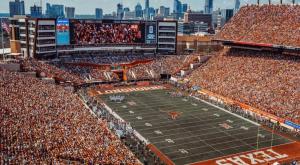 a crowd of people in the stands at a football game at Visit for Formula 1, Stay at Magic Tree House at UT, Dtwn in Austin
