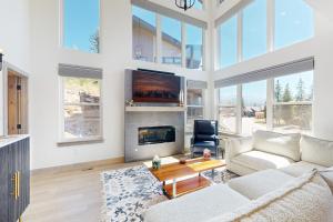 a living room with a couch and a fireplace at Rendezvous Retreat in Fraser
