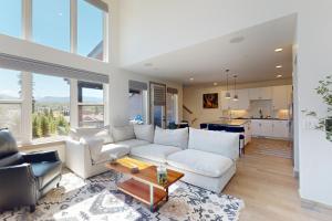 a living room with a white couch and a table at Rendezvous Retreat in Fraser
