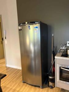 a stainless steel refrigerator in a kitchen next to a stove at LK Santo Agostinho 2 in Belo Horizonte +24 photos