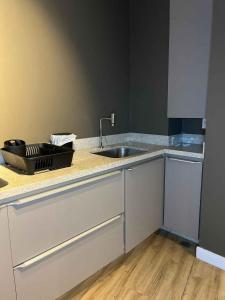 a kitchen with a sink and a counter top at LK Santo Agostinho 2 in Belo Horizonte