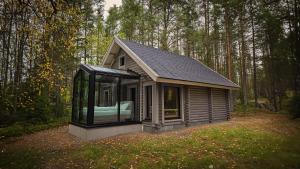 a small cabin in the middle of a forest at Sky Lodging - sleeping under the stars - private cottage in Rovaniemi