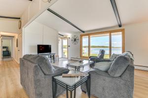 een woonkamer met twee banken en een tv bij Serene Lake Huron Gem with Fishing Dock! in De Tour Village