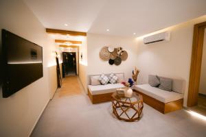 a living room with two couches and a flat screen tv at Makai Pyramids Guest House in Cairo