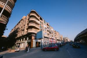 a red car is parked in front of a building at Makai Pyramids Guest House in Cairo