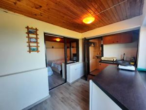 een keuken met een aanrecht en een kamer met een bed bij Luccia Apartments - Country House at Monastery Saint Naum in Ohrid