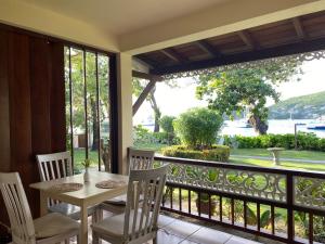 a balcony with a table and chairs and a view of the water at Gingerbread Suites in Port Elizabeth