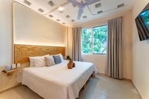 a bedroom with a large bed and a window at Casa Jicama in Cancún +48 photos