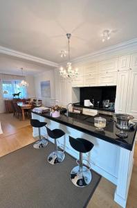 a kitchen with a black counter and bar stools at loren's villa in Mullini i Danit