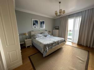 a bedroom with a bed and a large window at loren's villa in Mullini i Danit