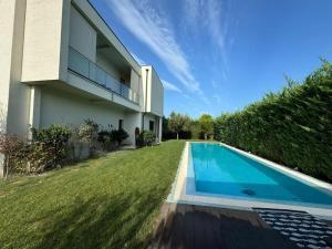 a house with a swimming pool next to a yard at loren's villa in Mullini i Danit
