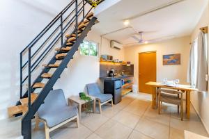 a living room with a staircase and a table and chairs at Casa Jicama in Cancún