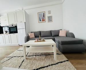 a living room with a couch and a coffee table at Grandview Central Residence in Baia Mare
