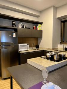 a kitchen with stainless steel appliances and a counter top at LK Santo Agostinho 4 in Belo Horizonte