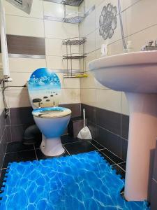 a bathroom with a toilet and a sink at Casa Otilia in Iaşi
