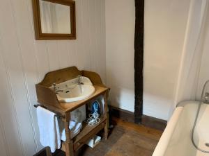 a bathroom with a sink in a room at Quay Cottage in Sandwich, UK in Sandwich +17 photos