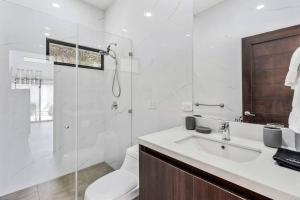 a bathroom with a toilet and a sink and a shower at CU19 New 3 Bdrm Mod Home with Casita Prv Pool in Villarreal