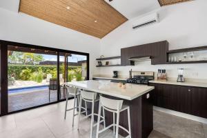 a kitchen with a large island with bar stools at CU19 New 3 Bdrm Mod Home with Casita Prv Pool in Villarreal
