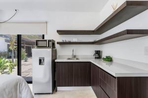 a kitchen with a sink and a refrigerator at CU19 New 3 Bdrm Mod Home with Casita Prv Pool in Villarreal