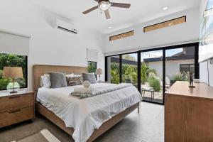 a bedroom with a large bed and large windows at CU19 New 3 Bdrm Mod Home with Casita Prv Pool in Villarreal