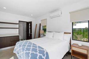 a bedroom with a large white bed and a window at CU19 New 3 Bdrm Mod Home with Casita Prv Pool in Villarreal