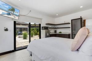 a bedroom with a white bed and a large window at CU19 New 3 Bdrm Mod Home with Casita Prv Pool in Villarreal
