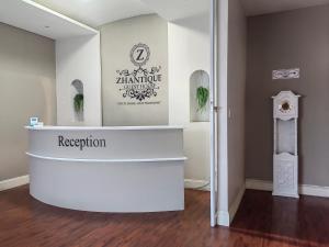 a museum exhibit with a white counter and a sign at Zhantique Guest House 2- Unit 11 in Boksburg