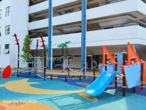 a playground in a building with a slide at Af Homes in Tangga Batu