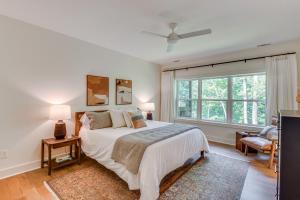 a bedroom with a bed and a large window at Sapphire Lakefront Cabin with Dock, Kayaks and Canoe! in Sapphire