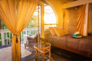 a living room with a couch and a window at Kona Ironman Family Home, Secluded Paradise in Kailua-Kona +34 photos