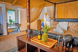 a bedroom with a bed and a table with a pineapple at Kona Ironman Family Home, Secluded Paradise in Kailua-Kona