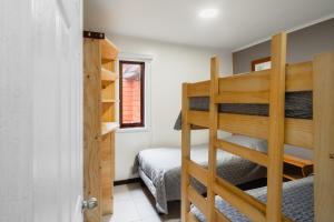 Ліжко або ліжка в номері Pucón Rec-Lodge Cabaña Loro Tricahue