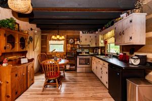 a large kitchen with a table and chairs in it at Azalea Garden Inn in Blowing Rock