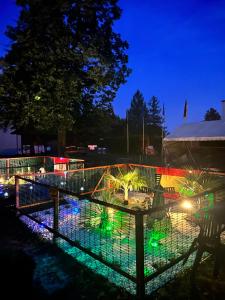 a fence with lights in a park at night at Eco Iglu The Secret of Comfort 5 Stars in Milmersdorf