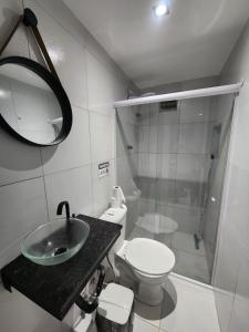 a bathroom with a sink and a toilet and a mirror at Pousada BOB Suítes in Porto De Galinhas +86 photos
