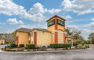 a hotel with a sign on top of a building at Extended Stay America Select Suites - Jacksonville - Southside - St Johns Towne Ctr in Jacksonville